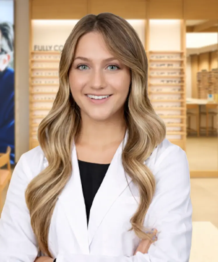 Dr. Megan Sales wearing a white coat and smiling, stands inside an eyewear store.